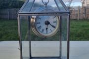 Table clock in a glass lantern.
