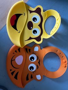 Two animal themed plastic feeding bibs