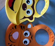 Two animal themed plastic feeding bibs