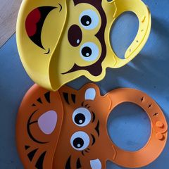 Two animal themed plastic feeding bibs