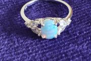 Ring made of 925 silver with oval opal of blue shade and cubic zirconia.