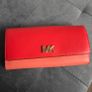 Michael Kors red and pink wallet with gold-tone MK logo. Multiple card slots and a zipped coin compartment. In perfect condition apart from some minor wear inside, which is not noticeable when using it, as shown in the photos. Image 3