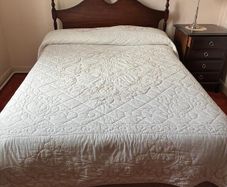 Double bed with wooden headboard and matching locker