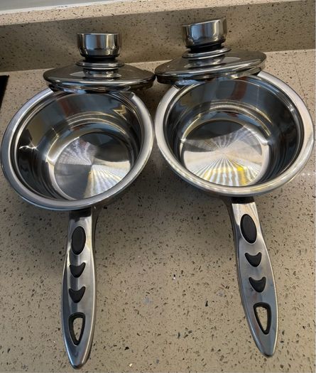 stainless steel saucepans featuring "Thermo Control" knobs on the lids