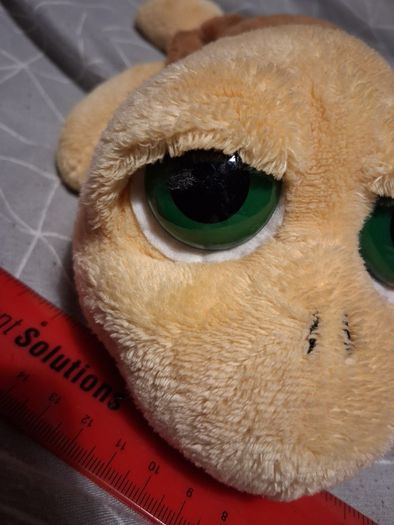 Turtle soft toy with large green eyes