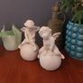 Lovely Vintage Pair of Ceramic Baby Winged Angels Sitting on Globes with a Very Tactile Cream Coloured Crackle Glaze Image 2