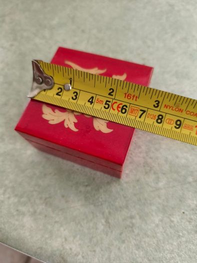 A small wooden trinket / gift box painted red with hand painted flower.