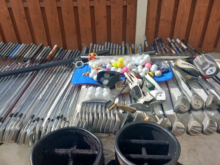 A selection of Golf clubs. Bags and golf balls.