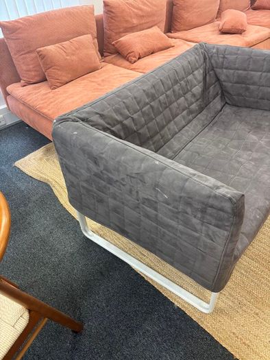 Grey quilted sofa with white metal frame