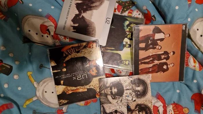 bag of U2 promo CD singles, CD albums and DVD sets