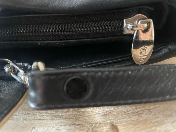 Tula black leather tote bag with a shoulder strap.