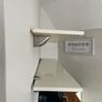 A pair of e floating wall shelves mounted on decorative metal shelf brackets. Image 3