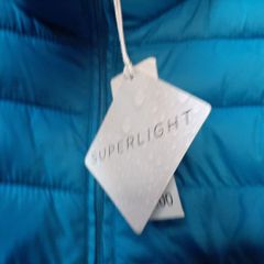 New blue jacket with hood and new baseball cap tag attached