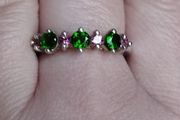 A 925 sterling silver ring with green and pink stones.