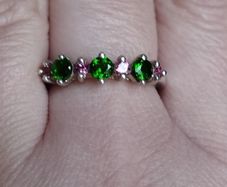 A 925 sterling silver ring with green and pink stones.