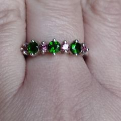 A 925 sterling silver ring with green and pink stones.