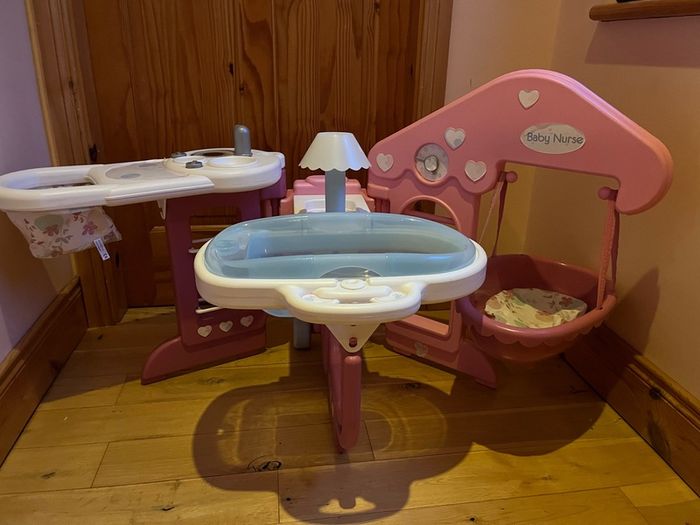 Baby doll play centre with high chair, bath and cot.