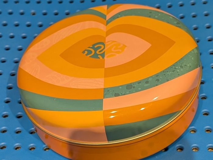 Colourful circular tin box