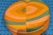 Colourful circular tin box