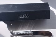 A collectible knife made of polished pewter with a stainless steel blade from Carrol Boyes.