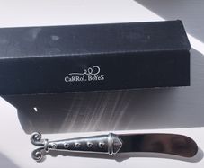 A collectible knife made of polished pewter with a stainless steel blade from Carrol Boyes.