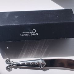 A collectible knife made of polished pewter with a stainless steel blade from Carrol Boyes.