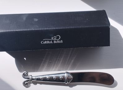 A collectible knife made of polished pewter with a stainless steel blade from Carrol Boyes.