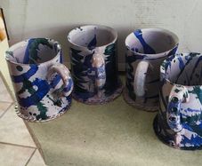 Set of 4 Irish pottery mugs featuring blue and green marbled glazes
