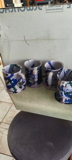 Set of 4 Irish pottery mugs featuring blue and green marbled glazes