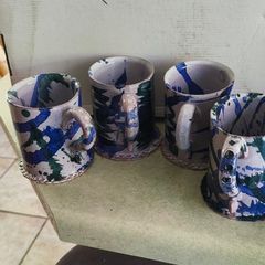 Set of 4 Irish pottery mugs featuring blue and green marbled glazes