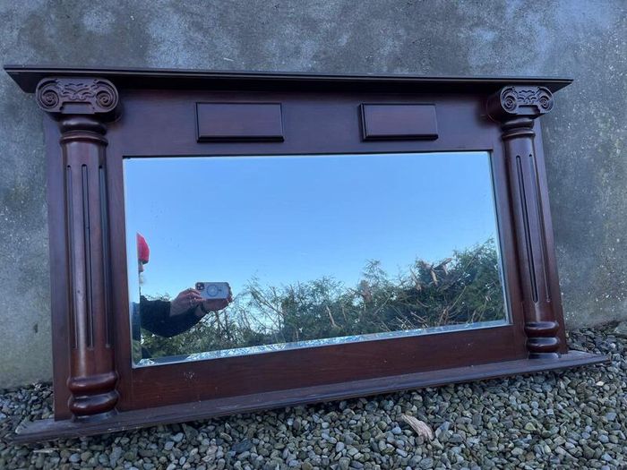 Wooden fireplace surround with carved details