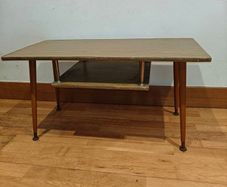 Very cute mid century side table with magazine rack.