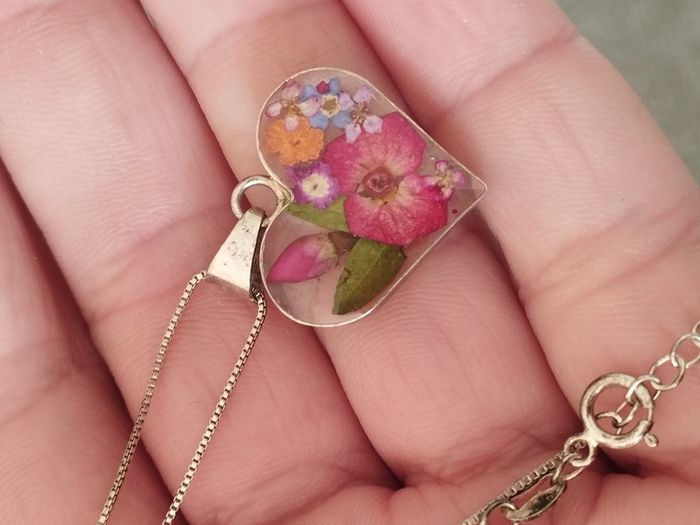Handcrafted 925 sterling silver necklace with a heart-shaped pendant featuring a floral pattern.