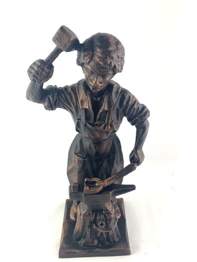 Vintage metal figurine of a blacksmith