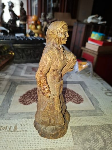Peasant woman c1950s Wearing a Headscarf and Apron while carrying a bundle of provisions, features detailed facial expressions, textured clothing folds, and a base characteristic of regional decorative collectibles, Postage Available or Collection,
