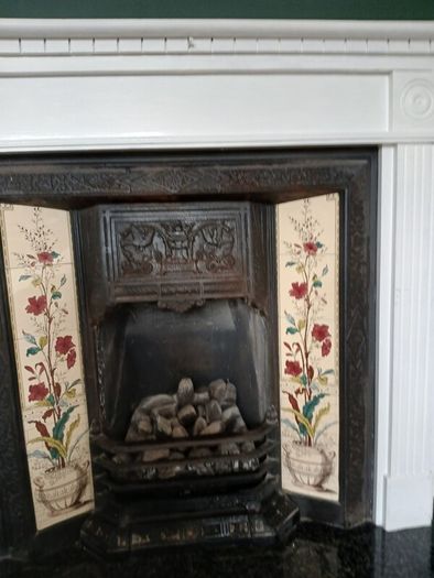 Fireplace in cast iron with wooden surround (painted white) and black marble hearth.   Perfect condition