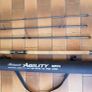Shakespeare Agility Spin fishing rod. 11 feet (3.30 meters) in length. The item includes a black carrying tube with a strap for transport. Image 3