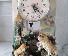 Mantel clock features a sculpted bulldog scene