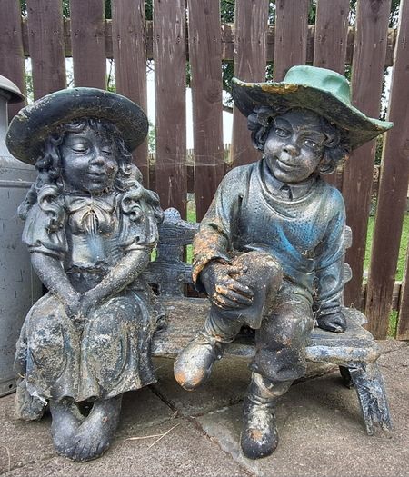 Stone Boy & Girl on bench
