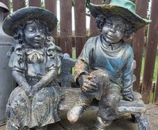 Stone Boy & Girl on bench