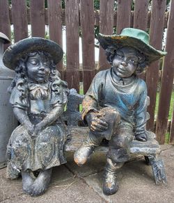 Stone Boy & Girl on bench