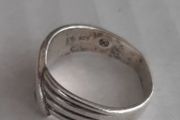 Silver ring clasping hands