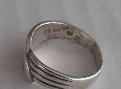 Silver ring clasping hands
