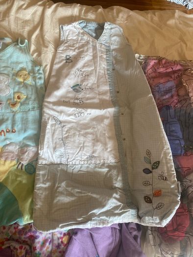 10 all in ones, 3 baby sleep bag, 4 pink blankets