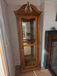 Ornate oak display cabinet with light. 5 glass shelves, mirror back