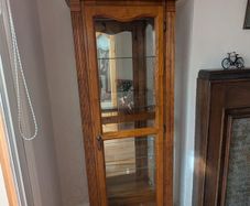 Ornate oak display cabinet with light. 5 glass shelves, mirror back