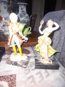A Pair of Italian Depose Figurines The figurines depicts a 18th century Rococo style attire