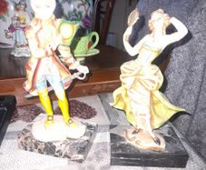 A Pair of Italian Depose Figurines The figurines depicts a 18th century Rococo style attire