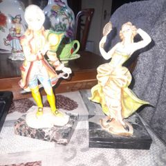 A Pair of Italian Depose Figurines The figurines depicts a 18th century Rococo style attire