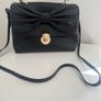 RED V Valentino genuine black leather crossbody bag with large bow and pink interior lining Image 3